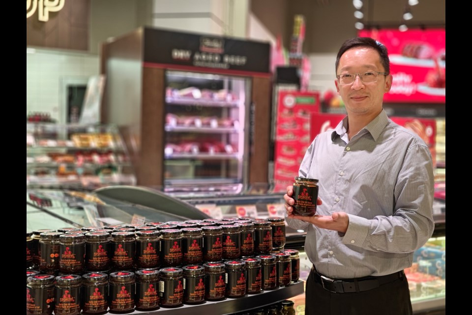 Bradford entrepreneur and owner of Yehs Innovations Inc., David Yeh, is seen in a supermarket carrying his new vegan, gluten-free garlic chili oil sauce SoSecret.
