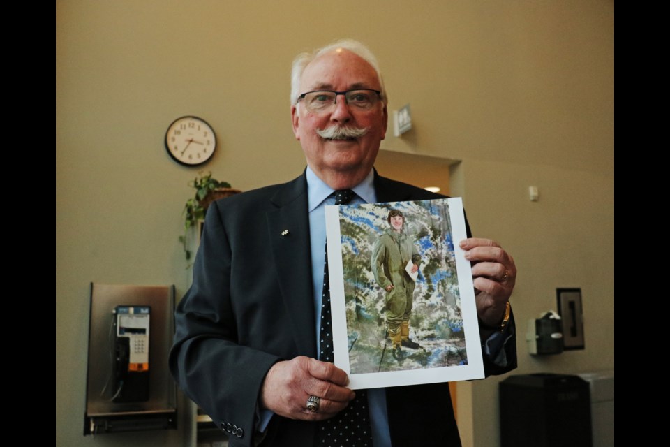 Bradford resident and retired Lt.-Col. Ferguson Mobbs holds one of the photographs he took of different uniforms and flight suits from 1924 to modern day to celebrate the upcoming 100th anniversary of the Royal Canadian Air Force.