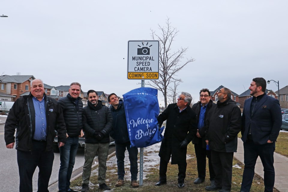 Mayor James Leduc (centre right) and Ward 5 Coun. Peter Ferragine (centre left) who also chairs the community and traffic safety advisory committee are joined by other members of council in unveiling a speed camera warning sign on Professor Day Drive in Bradford on Feb. 1.