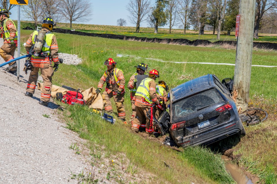 Fire crews work to extricate the driver following a single-vehicle crash in Bradford Thursday afternoon. 