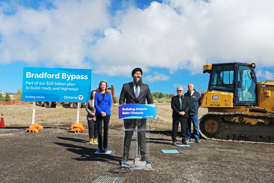 Joined by York—Simcoe MPP Caroline Mulroney on his left and Bradford Mayor James Leduc on his right, Minister of Transportation, Prabmeet Sarkaria announced the province has awarded a $16-million contract to AECOM for the detailed design of the western 6.5-kilometre portion of the Bradford Bypass route from Highway 400 to County Road 4 (Yonge Street), at a construction site on that street just north of Line 8 on Thursday morning.