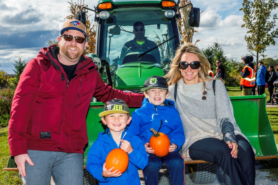 The Philpott family check one off their bucket list as they get ready for the hayride at Pumpkin Fest in Bradford