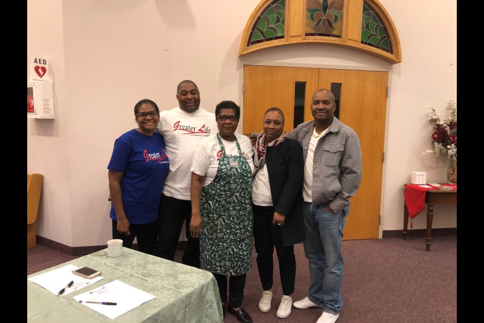 Volunteers Debbie, Shawn, Norma, Sophia and Orville welcome guests to the dinner at the front of the church. Natasha Philpott/BradfordToday