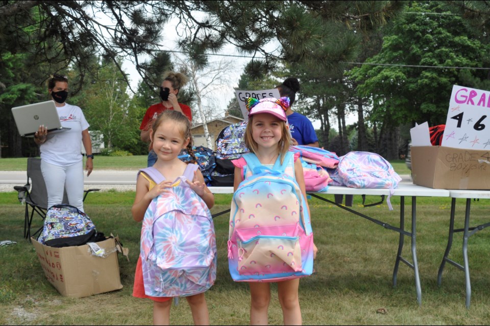 Free backpacks were given out at the Greater Life Community Church on Sunday. Mya, left, is starting her first year of Junior Kindergarten, and Jocelyn, right, will be attending Grade 1. 