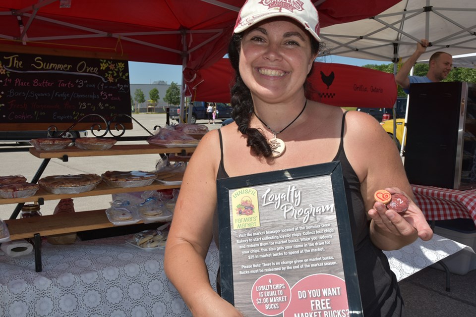 Innisfil Farmers' Market manager Jaime Grant, introducing the Loyalty Coin program last year. Miriam King/Bradford Today