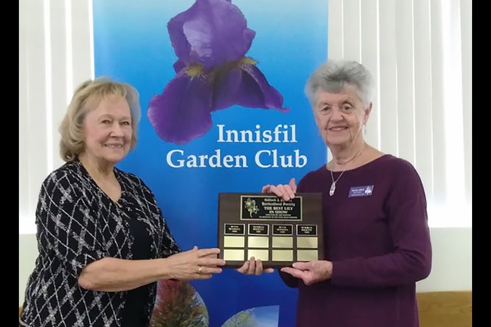 Linda Becic, left, presents trophy to Marilyn Elliott, winner of Most Points Overall in the Club's Flower Shows. SUBMITTED