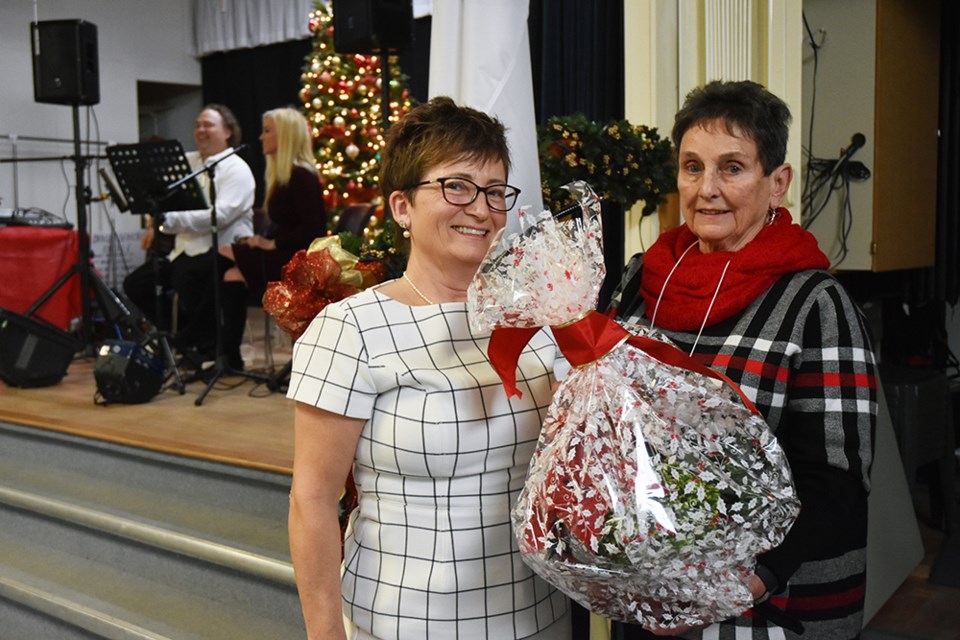 Linda Stewart, left, presents out-going president JoAnne Norton with a gift thanking her for her work. Miriam King/Bradford Today