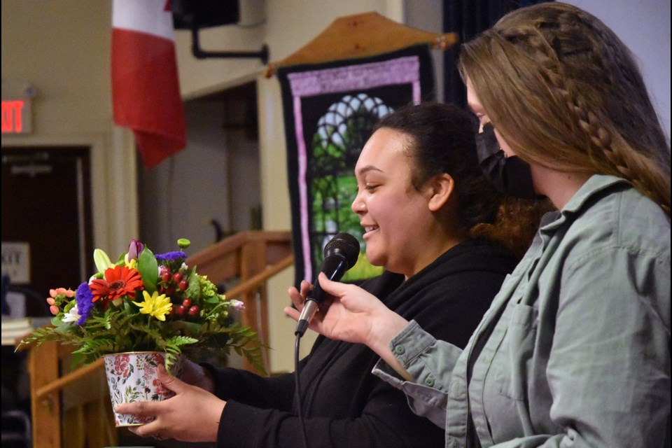 Designer Teresa Aukema displays a finished floral arrangement, at Anniversary Meeting of the Bond Head Bradford Garden Club.