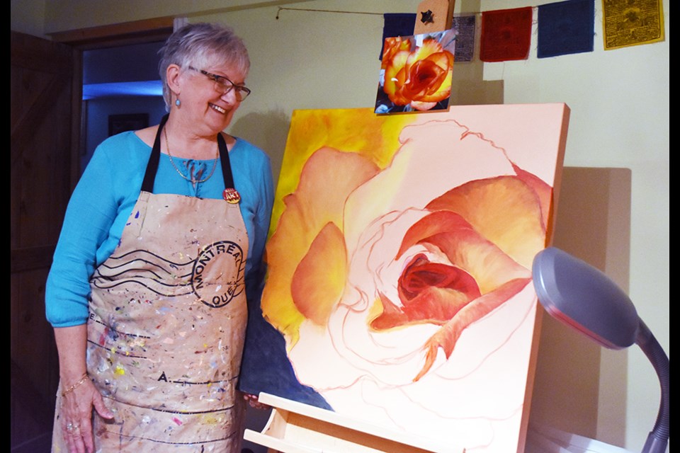 Maureen Joyce, working on a new painting, inspired by a rose from her own garden. Miriam King/Bradford Today