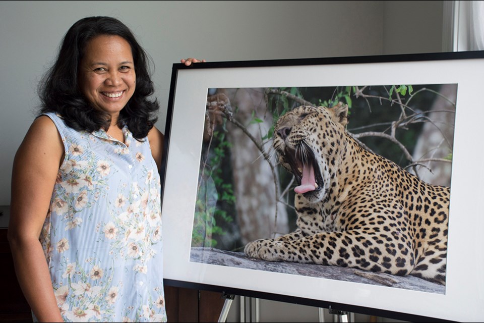 Photographer Safani Gunasekera, with a photo of a young leopard, taken in Sri Lanka. Miriam King/Bradford Today