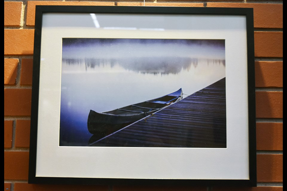 Brooding photo of a canoe in the mist, by Jim Craigmyle - on exhibit at the Lakeshore Branch of the Innisfil idea Lab and Library. Miriam King/Bradford Today