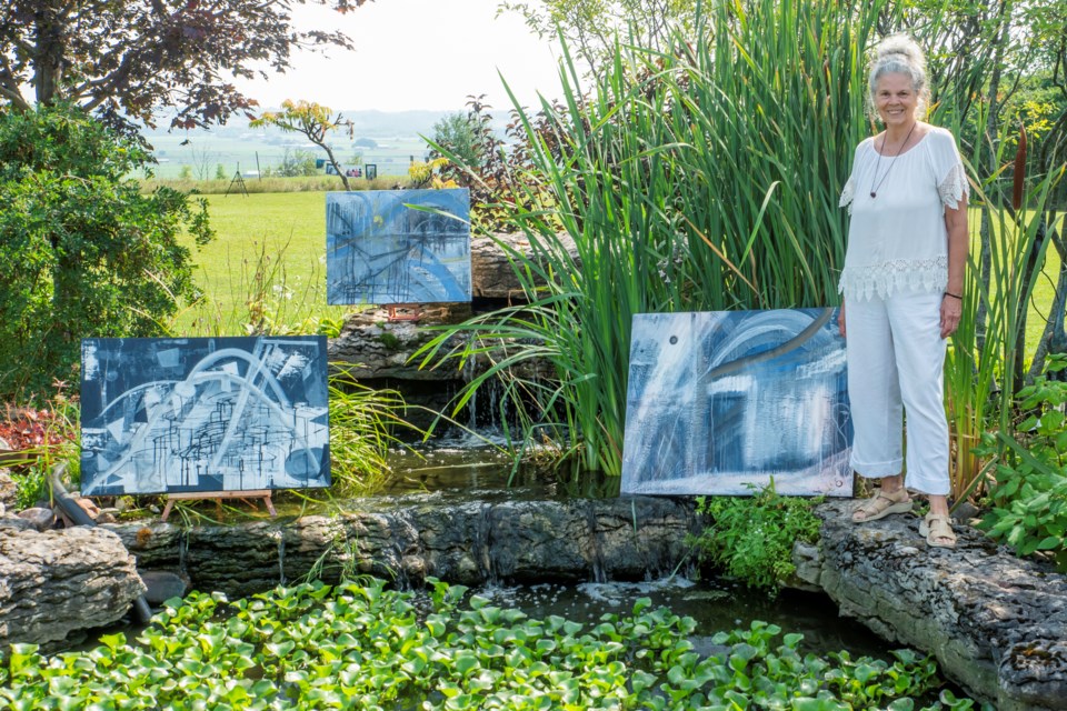 Artist Karen Lee stands with her works for the filming of the Passion Made video