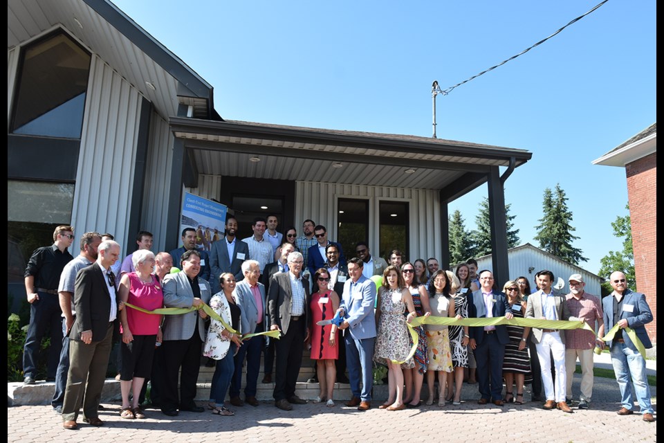 Cutting the ribbon at the new Bradford office of Crozier Consulting Engineers, July 25. Miriam King/BradfordToday
