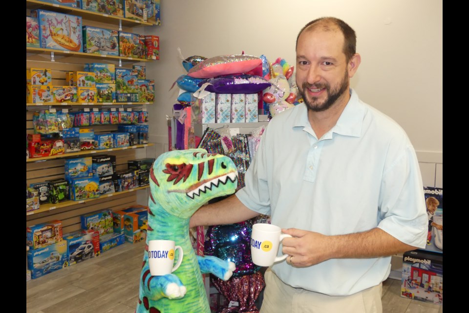 Experience Toys and Games co-owner Brian Hayden and a prehistoric pal.  Jenni Dunning/BradfordToday