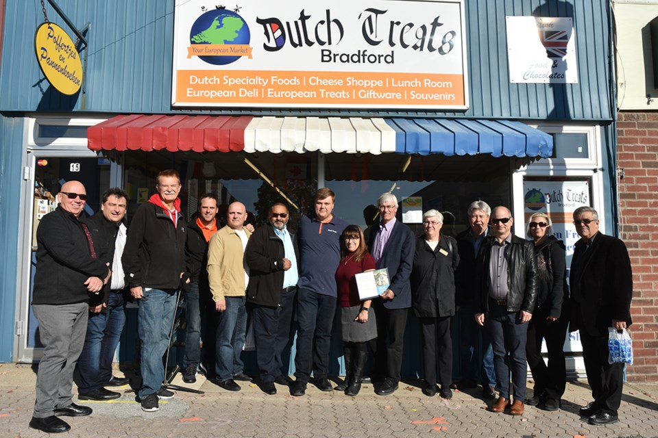 Celebrating the store's 65th anniversary, Dutch Treats owners Rob and Tina Bots are joined by Mayor Rob Keffer and members of Council, members of the Bradford Board of Trade on Oct. 19. Miriam King/Bradford Today