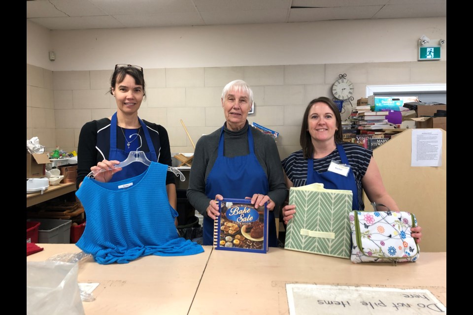 Mother-daughter volunteer team Tammy and Annette Holtrop and Board Member and volunteer, Rachel Bokma sorting out some newly received items. Natasha Philpott/BradfordToday