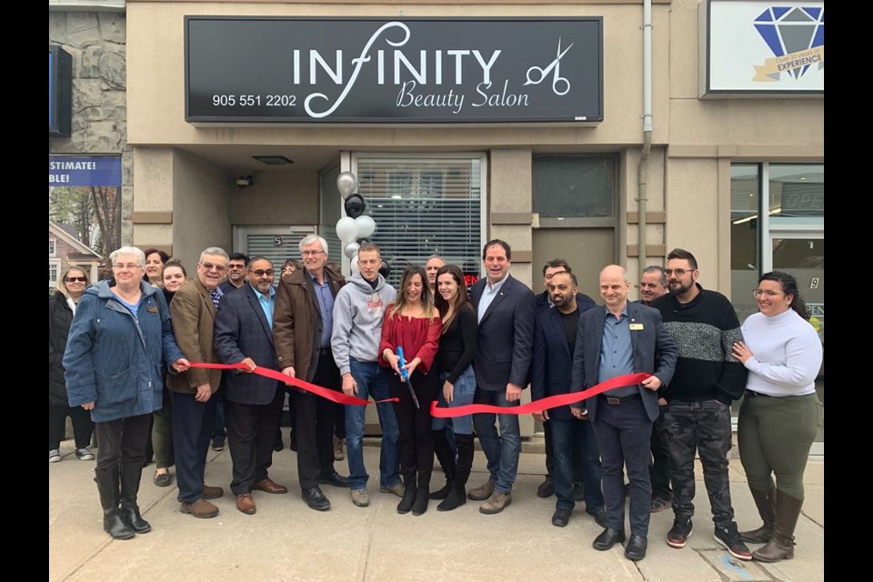 Salon owner, Adelina Brito cuts the ribbon at her official grand opening of Infinity Beauty Salon with family, friends, Mayor Rob Keffer, members of council, MP Scot Davidson, and the Bradford Board of Trade. Submitted Photo.