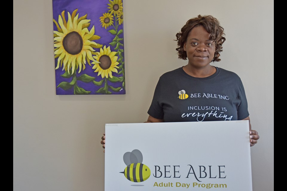 Bee Able Inc. founder Claudett Bailey, with a painting by Meade Helman, is aiming to create a “hive” of inclusive programs for adults with special needs. Miriam King/Bradford Today