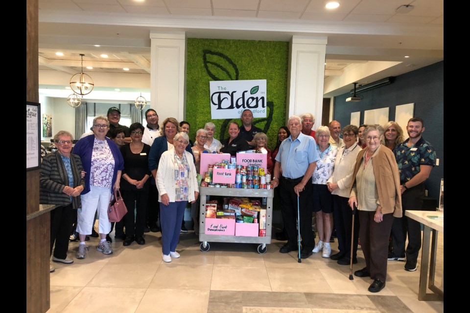 The residents and staff of The Elden were happy to present their collection of non perishable food items to the Helping Hand Food Bank on Thursday morning. Natasha Philpott/BradfordToday