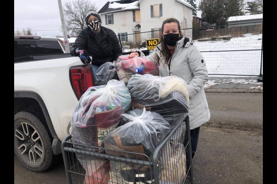 Bradford Women's+ Group volunteers Tina and Jenn dropping off purses to the Helping Hand Food Bank. Submitted.