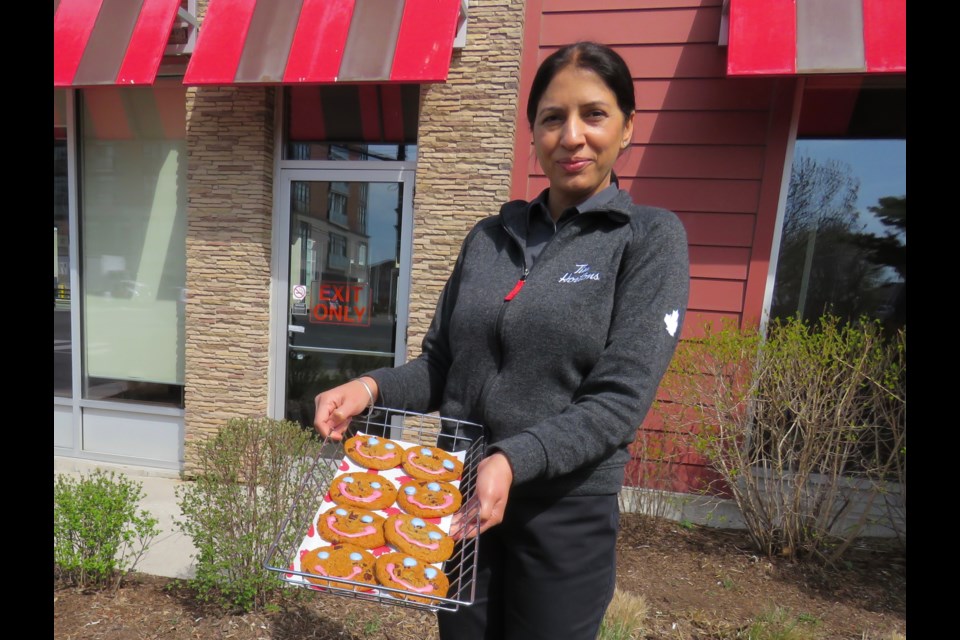 Harmeet Grewal holds a tray of Smile cookies that will help support the Big Brothers Big Sisters Peel York. Cookies can be pre-ordered and will also be available at all Bradford Tim Hortons locations May 1-9.