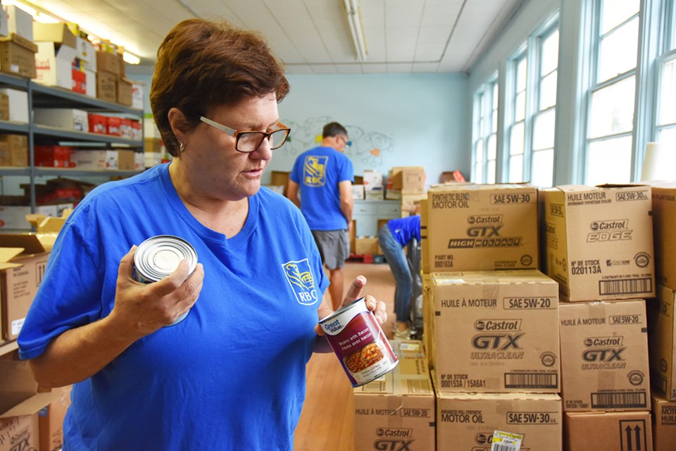 Sorting by food type and best-before date, Jacki Kerr helps out at the food bank, as part of Team RBC. Miriam King/BradfordToday