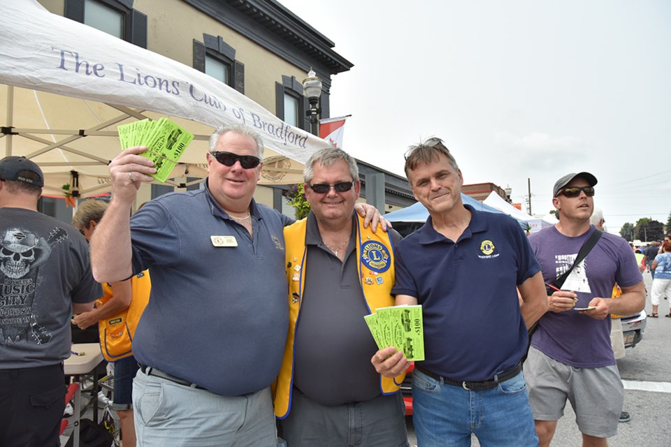 Bradford Lions, from left, Jamie Jones, Jim Slykhuis and Bill Bargent sell Lions Mammoth Draw tickets at Carrot Fest. Miriam King/BradfordToday