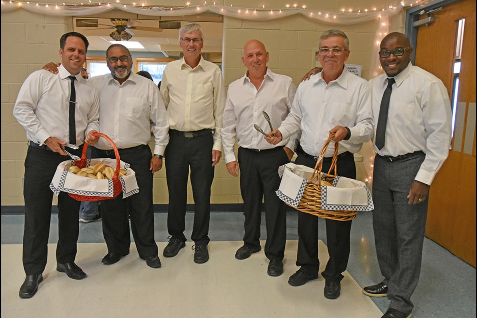 From right, Pastor Eaton Hope Grant is joined by Deputy Mayor James Leduc, Coun. Mark Contois, Mayor Rob Keffer, Coun. Raj Sandhu and Coun. Peter Ferragine, serving Thanksgiving dinner as they wrap up their term in office. Miriam King/BradfordToday