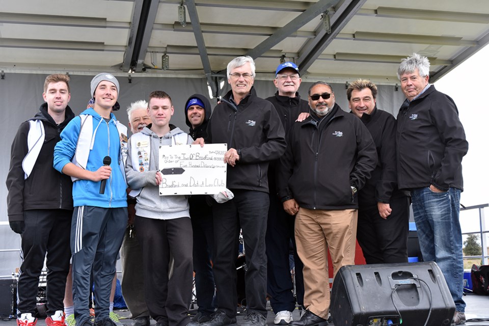 Leo's Club members present a cheque to the Town of Bradford West Gwillimbury, accepted by Mayor Rob Keffer and members of council. Miriam King/BradfordToday