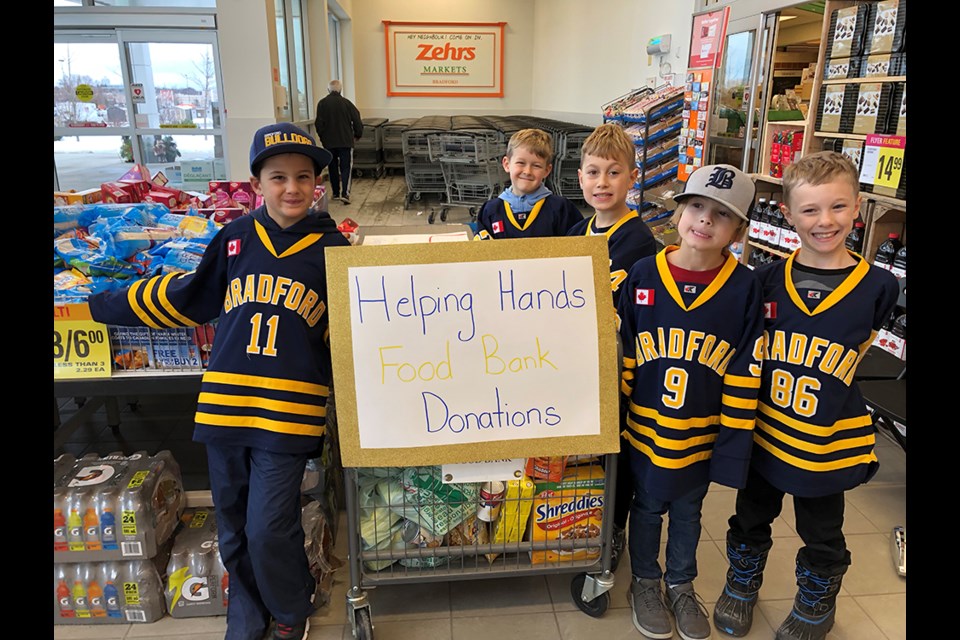 A real team effort. Players with the Bradford Bulldogs Novice A hockey team and coach Joe Lotto held a food drive at Zehrs, Nov. 17. Submitted photo 