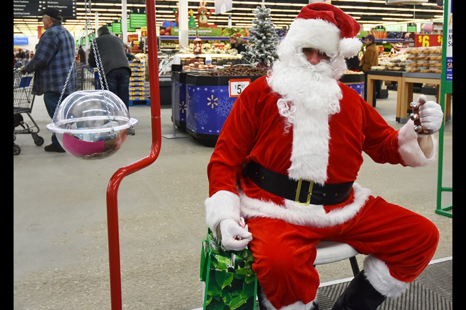 Santa lends a hand, for the Salvation Army Christmas Kettle Campaign at Walmart in Bradford. Miriam King/BradfordToday