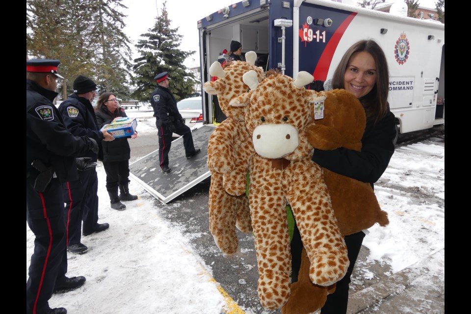 South Simcoe police Const. Ashley Keveva unloads some big stuffed animals. Jenni Dunning/BradfordToday