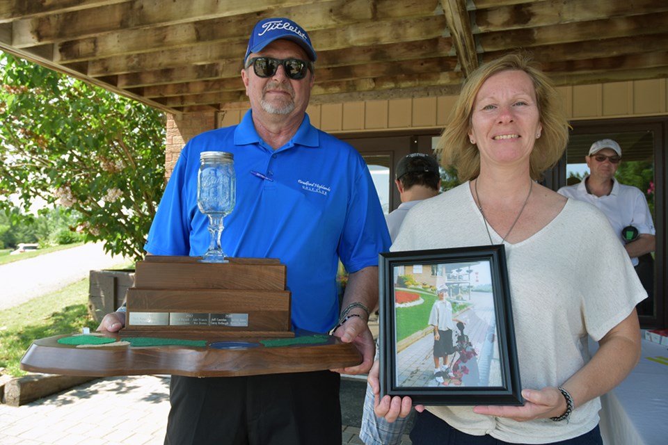 Bill and Sandra with trophy and photo of their son, Randy Bagg. Miriam King/Bradford Today