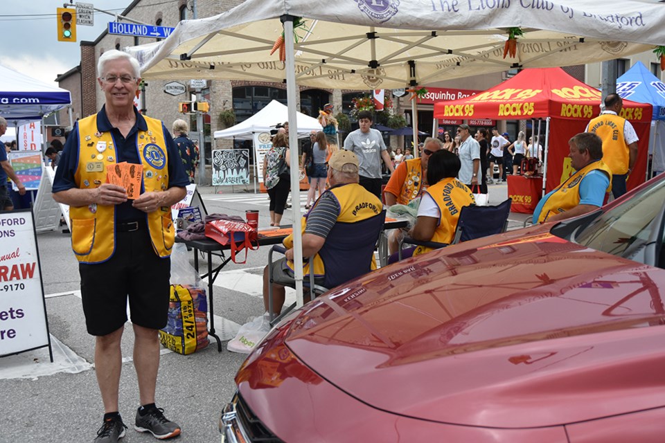 Selling tickets at the Bradford Lions' car display at Carrot Fest on Aug. 17. Miriam King/BradfordToday