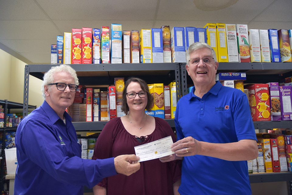 From right, Lefroy-Belle Ewart Legion president Mark Southcott presents a donation to food bank volunteer Donna van Bodegom and Pastor Howard Courtney. Miriam King/Bradford Today