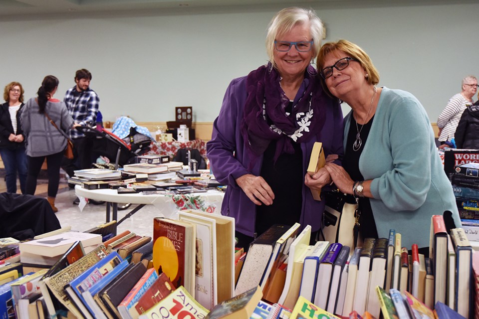 Mikki Nanowski, right, and Richardis Bianchi at the Used Book Table at the CWL Bazaar. Miriam King/Bradford Today