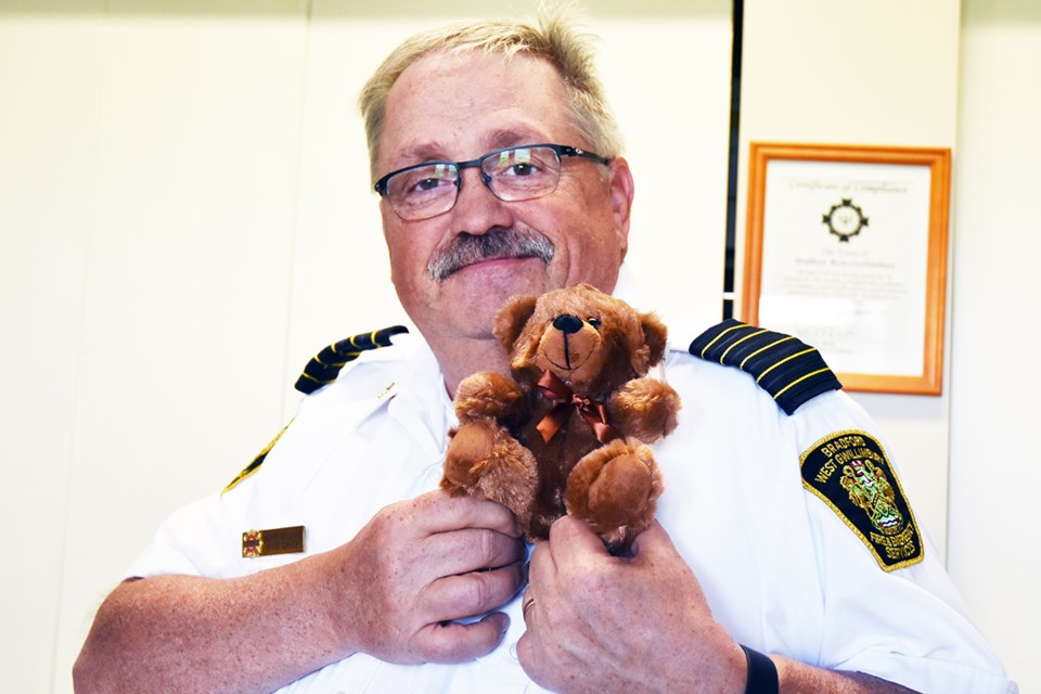 BWG Fire Chief Kevin Gallant with a stuffed bear. The fire department received a number of Quincy Project packages containing a stuffed animal, blanket and book to be handed out to children. Miriam King/Bradford Today