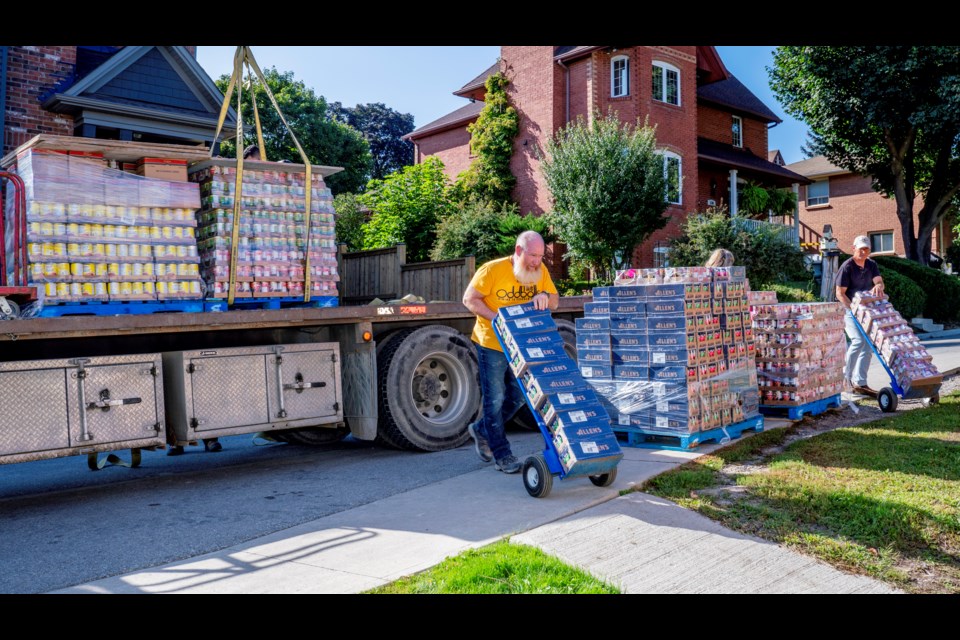 Local Lion and community volunteer Gavin Maclean helps unload a skid of food delivered Tuesday to Bradford's Helping Hand Food Bank.