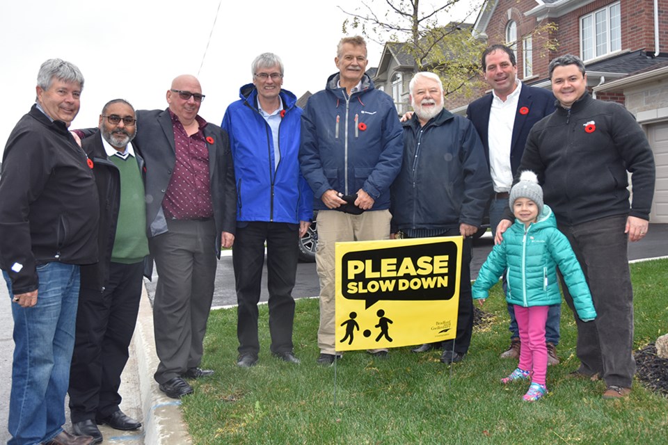 From right, Frank Naso and daughter Ada show new sign to supporters who include MP Scot Davidson, Councillors Gary Lamb and Gary Baynes, Mayor Rob Keffer, Coun. Mark Contois, Raj Sandhu and Ron Orr. Miriam King/Bradford Today