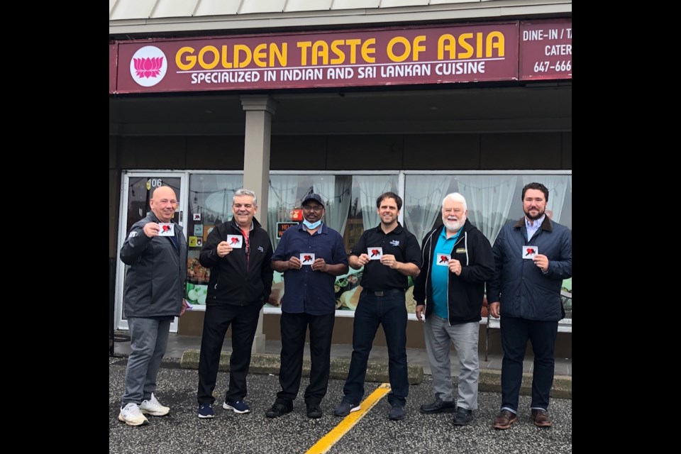 Members of the Accessibility Committee paid a visit to Golden Taste of Asia’s  Ganesh Ponniah to help promote the new service dog stickers for business windows 