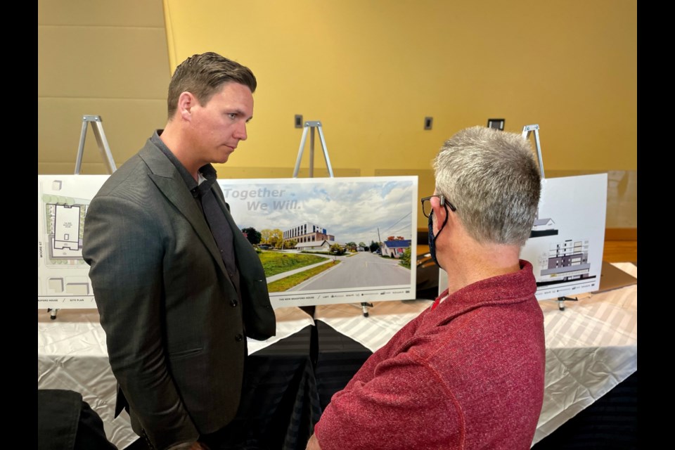 Architect Michael Gallant of Lett Architects speaks to a resident during an information session hosted by LOFT Community Services on its new Bradford House development.