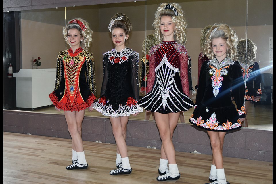 Four dancers with the Miller School of Irish Dance - from left, Avery and Madalynn McGregor, Teagan Harrison and Teagan Mugford, in their competition dresses. 'It adds to your confidence, to have your own dress,' said Harrison. Miriam King/Bradford Today