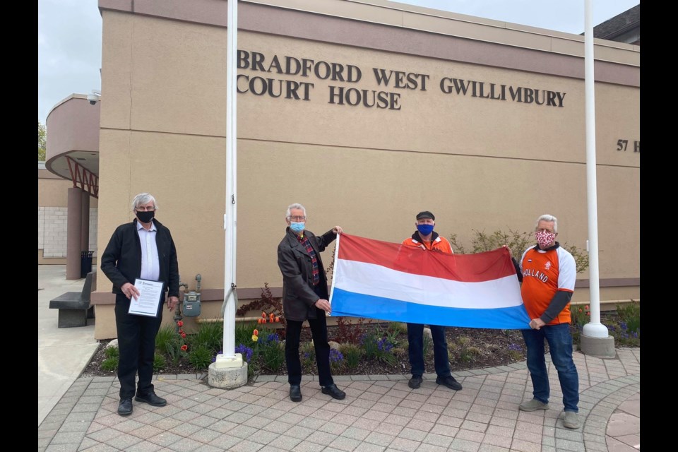 BWG Mayor Rob Keffer (left) raises the Dutch flag on May 5th to commemorate Netherlands Liberation Day. (Picture Right: Albert Wierenga & his brother Carl, and Cor Den Bleker ). 