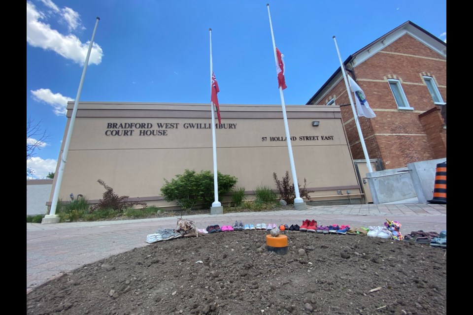 Residents have started to place kids’ shoes outside the Bradford Court House in memory of the 215 childrens’ bodies discovered last week at a former residential school in Kampools, BC. 