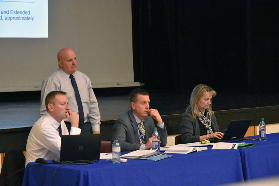 From left: SCDSB Manager of Planning and Enrolment Andrew Keuken, Superintendent of Business and Facility Services Brian Jeffs (standing), Superintendent of Education for Area 4 Daryl Halliday, and executive assistant Deb Deeth listen to comments at a public meeting in Bradford. Miriam King/Bradford Today