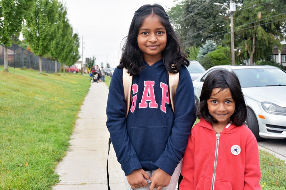 Sisters heading off to class on the first day of school at Fred C. Cook Public School in Bradford. Miriam King/Bradford Today