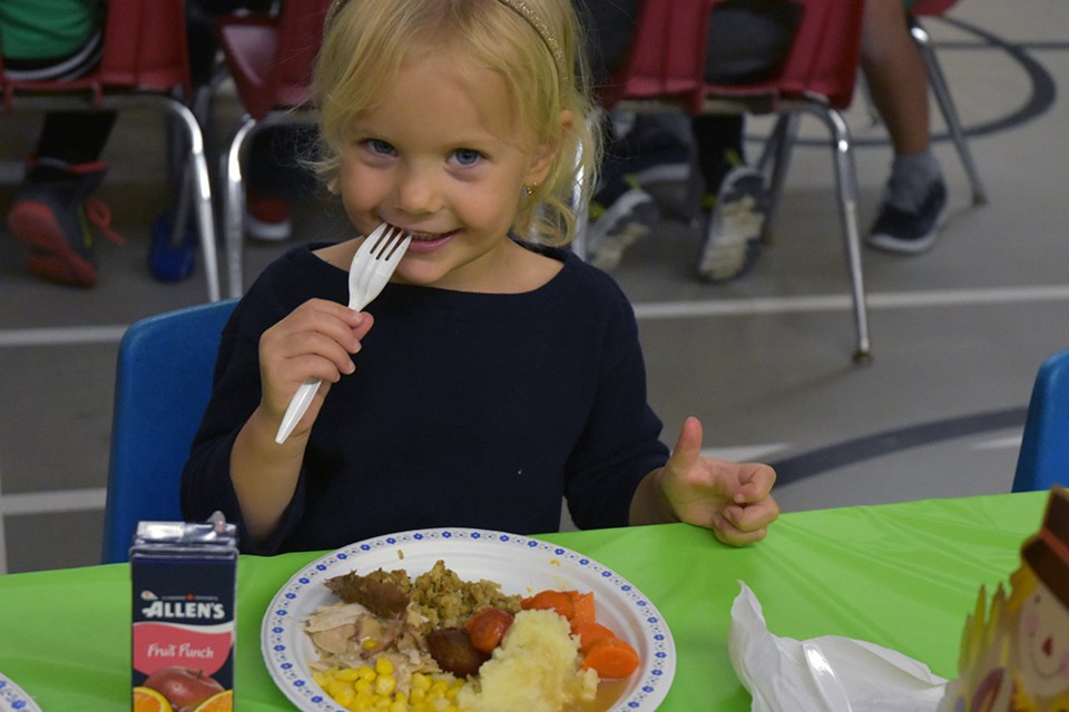 Kindergarten student at Sir William Osler Public School enjoys a turkey lunch. Miriam King/Bradford Today