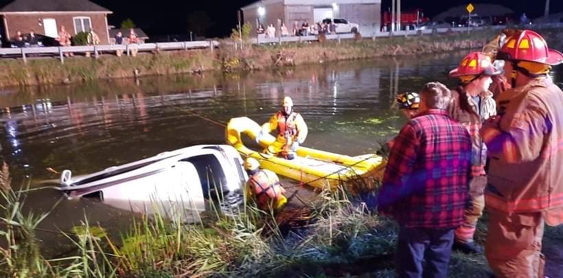 Emergency crews on scene retrieving vehicle from the canal.