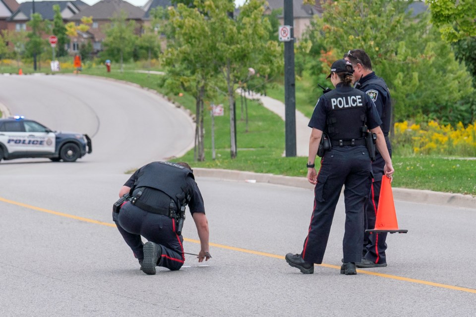 South Simcoe police examine what appears to be a shell casing on the road.