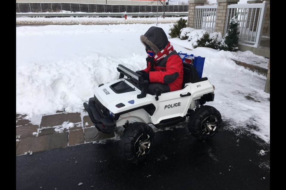 Little Skyler enjoying his new gift from South Simcoe Police.